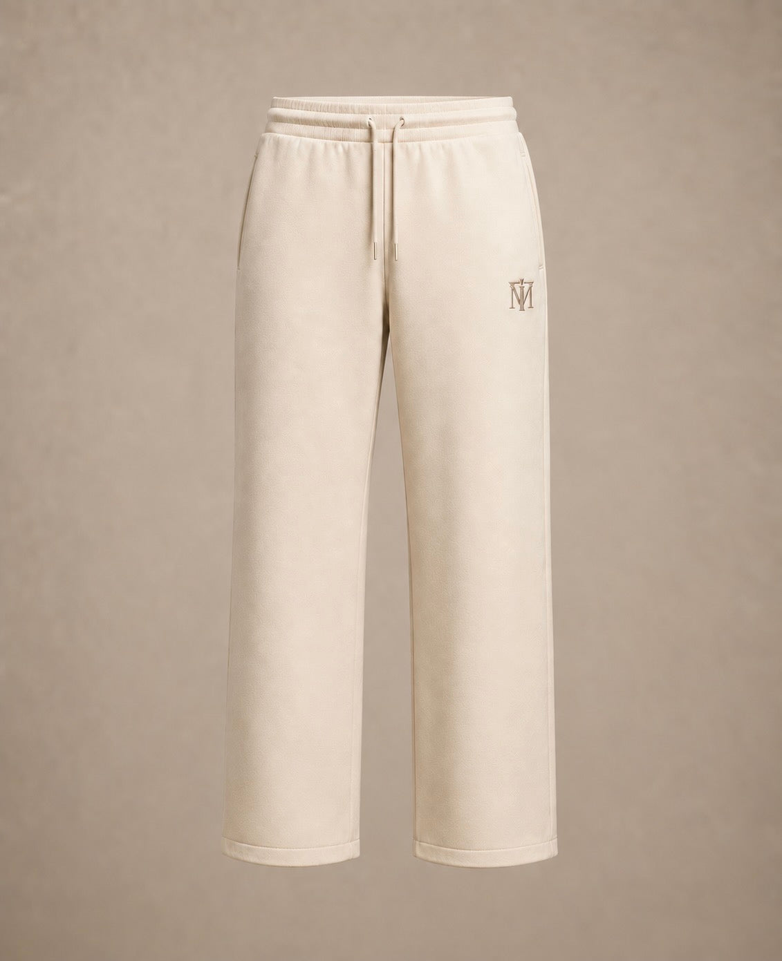 Cream-colored wide-leg sweatpants with a drawstring waist and a small embroidered logo on the left leg, shown against a neutral beige background.