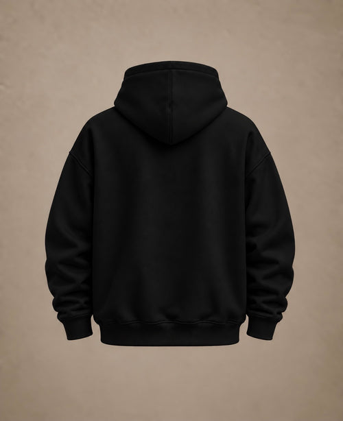 A black pullover hoodie shown from the back, centered against a textured beige background.